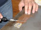 Spreading chocolate on a strip of the transfer sheet