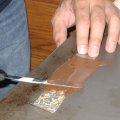 Spreading chocolate on a strip of the transfer sheet